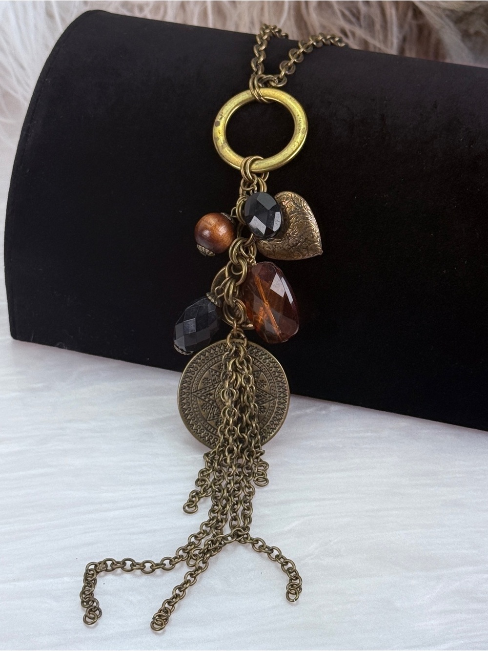Long layering, brass tone multi charm costume necklace
